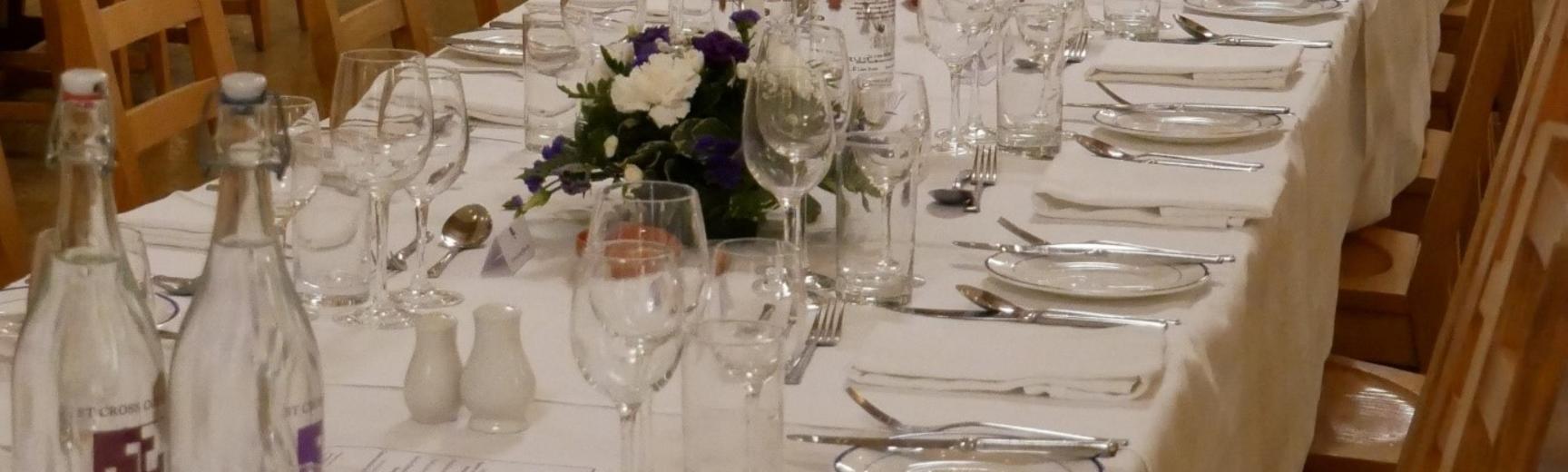 table with glasses and crockery on white cloth