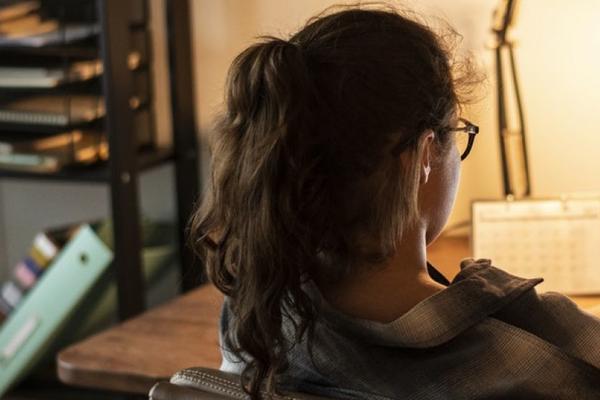 a woman studying at a laptop