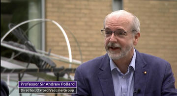 TV grab of Professor Andrew Pollard sat down head and shoulders shot in a suit.