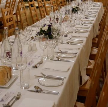 table with glasses and crockery on white cloth