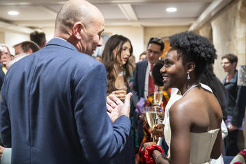 Guests chat together in the Saugman Common Room