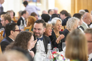 Guests chatting at a dinner for the 60th Anniversary closing weekend