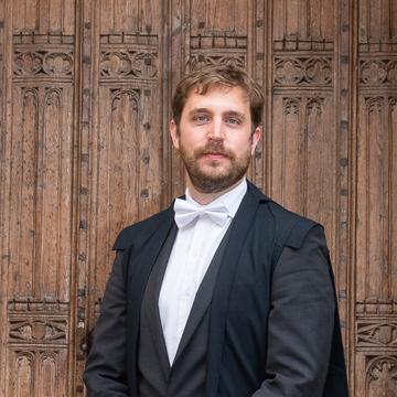 Santiago Bengoechea stood in front of Pusey house in a gown.