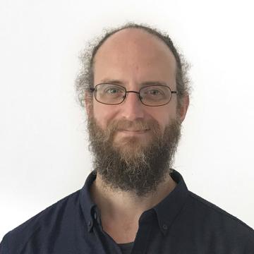 Peter Smith head and shoulders shot wearing a navy shirt on white background